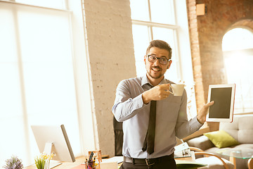 Image showing A young businessman working in office after promotion