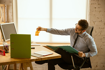 Image showing A young businessman working in office after promotion