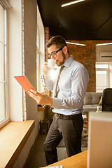 Image showing A young businessman working in office after promotion