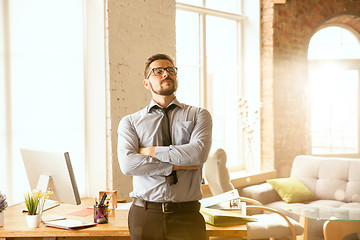 Image showing A young businessman working in office after promotion