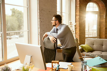 Image showing A young businessman working in office after promotion