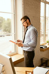 Image showing A young businessman working in office after promotion