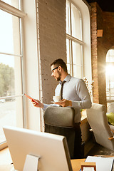 Image showing A young businessman working in office after promotion