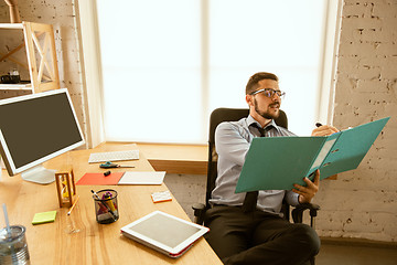 Image showing A young businessman working in office after promotion