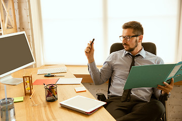 Image showing A young businessman working in office after promotion