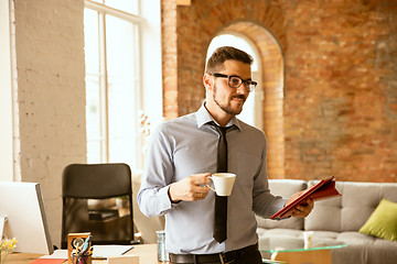 Image showing A young businessman working in office after promotion