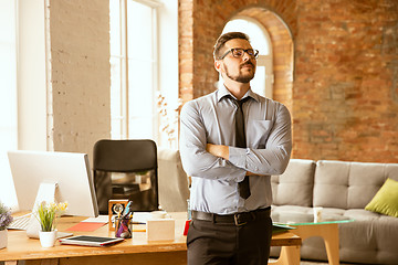 Image showing A young businessman working in office after promotion