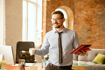 Image showing A young businessman working in office after promotion