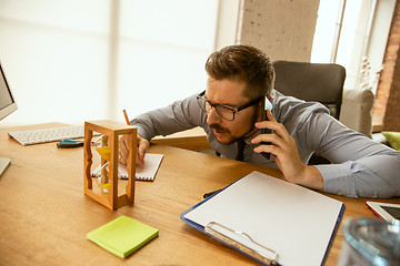 Image showing A young businessman working in office after promotion