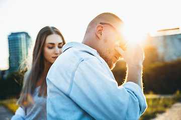 Image showing Tanned young caucasian couple, modern lovestory in film grain effect