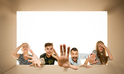 Image showing Shocked people opening the biggest postal package