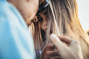 Image showing Tanned young caucasian couple, modern lovestory in film grain effect