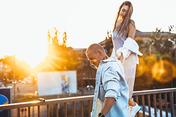 Image showing Tanned young caucasian couple, modern lovestory in film grain effect