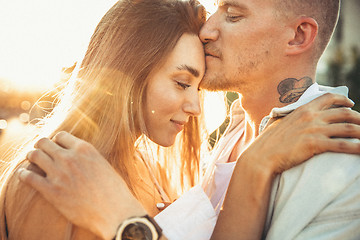 Image showing Tanned young caucasian couple, modern lovestory in film grain effect