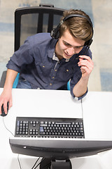 Image showing male call centre operator doing his job top view