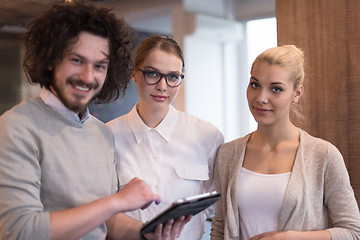 Image showing Business People Working With Tablet in startup office