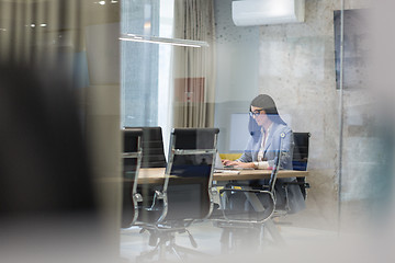 Image showing businesswoman using a laptop in startup office