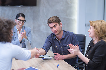 Image showing cloasing the deal in modern office interior