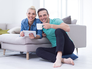 Image showing couple relaxing at  home with tablet computers