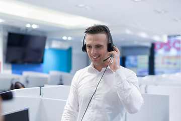 Image showing male call centre operator doing his job