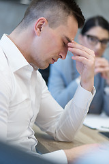 Image showing young businessman relaxing at the desk