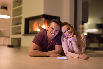 Image showing Young Couple using digital tablet on cold winter night