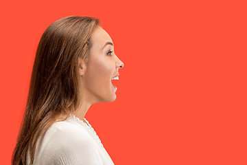 Image showing The happy business woman standing and smiling against red background.