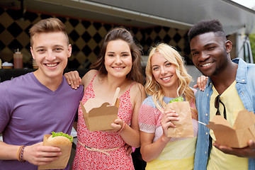 Image showing happy friends with wok and burger at food truck