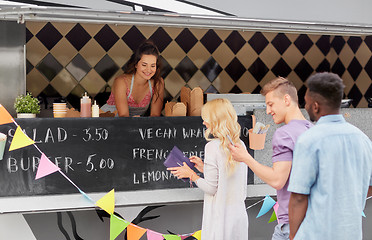 Image showing queue of customers and saleswoman at food truck