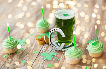 Image showing glass of beer, cupcakes, horseshoe and gold coins