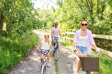 Image showing happy family with bicycles in summer park