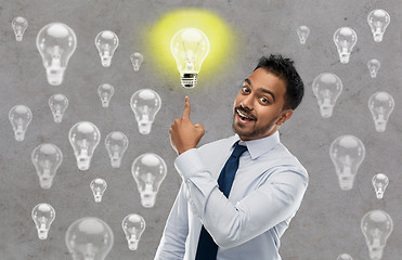 Image showing indian businessman pointing finger at light bulb