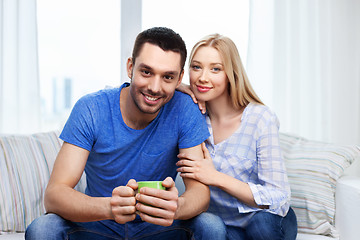 Image showing happy smiling couple sitting on sofa at home