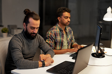 Image showing creative man with smartwatch working at office