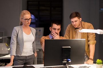 Image showing business team with computer working late at office