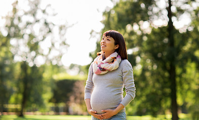 Image showing happy pregnant asian woman at park