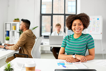 Image showing happy smiling african american woman at office