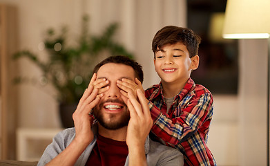 Image showing happy father and little son playing at home