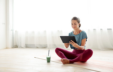 Image showing woman with tablet pc and drink at yoga studio