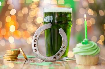 Image showing glass of beer, cupcake, horseshoe and gold coins