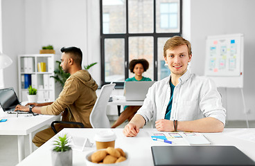 Image showing male creative worker with laptop at office