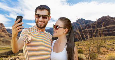 Image showing couple taking selfie by smartphone on grand canyon
