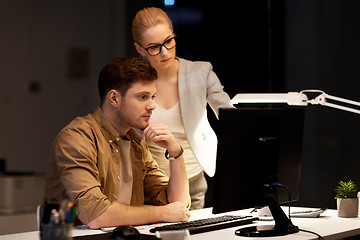 Image showing business team with computer working late at office