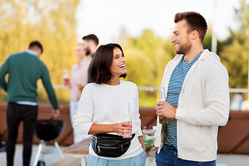 Image showing happy couple with drinks at rooftop party