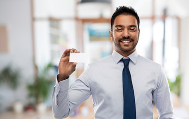 Image showing indian businessman with business card over office