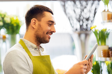 Image showing man with tablet pc computer at flower shop