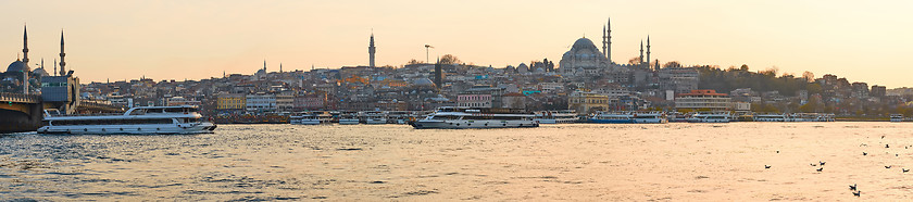 Image showing Tourist boat sails on the Golden Horn in Istanbul at sunset, Turkey.