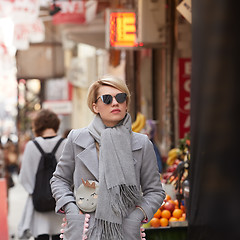 Image showing Young blond woman with sunglases on the street