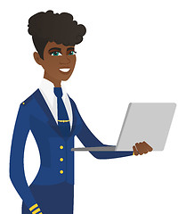 Image showing Young african-american stewardess using laptop.