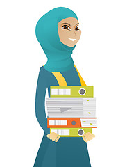 Image showing Muslim business woman holding pile of folders.